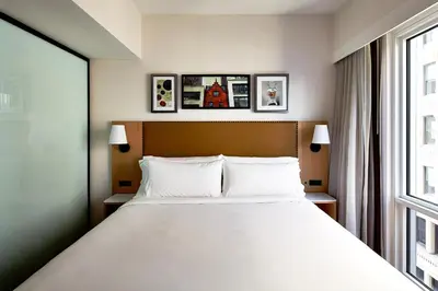 a bedroom with a large bed and a window at Hotel Indigo NYC Financial District by IHG in New York