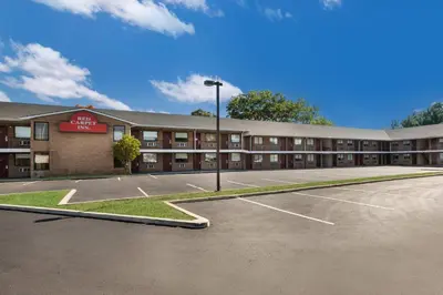 an empty parking lot in front of a hotel at Red Carpet inn Edison in Edison