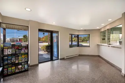 a grocery store aisle with glass doors and windows at Red Carpet inn Edison in Edison