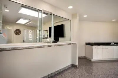a living room with a large mirror and a tv at Red Carpet inn Edison in Edison