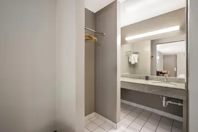 a bathroom with two sinks and a mirror at Red Carpet inn Edison in Edison