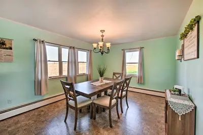 a dining room with green walls and a table and chairs at Quiet Elizabethville Home with Fire Pit and Views in Elizabethville