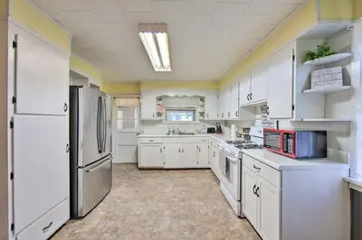 a kitchen with white cabinets and a refrigerator at Quiet Elizabethville Home with Fire Pit and Views in Elizabethville