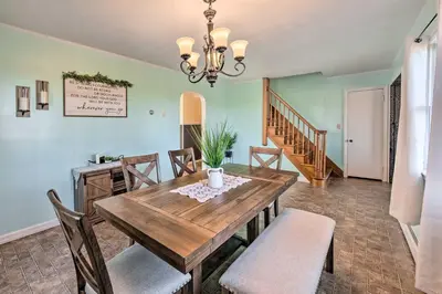 a dining room with a wooden table and chairs at Quiet Elizabethville Home with Fire Pit and Views in Elizabethville