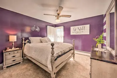 a bedroom with a bed and purple walls at Quiet Elizabethville Home with Fire Pit and Views in Elizabethville