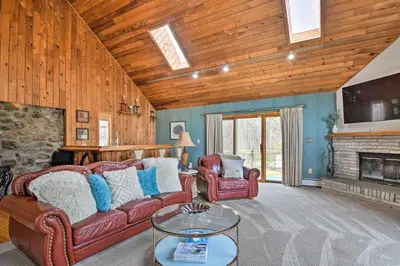 a living room with leather furniture and a fireplace at Decked-Out Home Hot Tub, Pool, Fire Pit and More! in Monroe