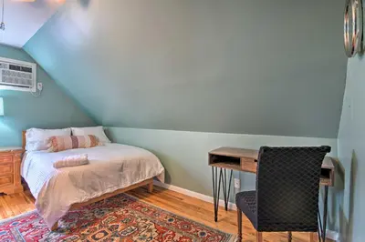 a small bedroom with a bed and a desk at Decked-Out Home Hot Tub, Pool, Fire Pit and More! in Monroe