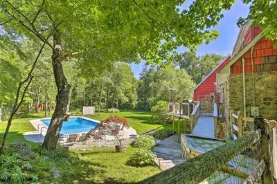 a backyard with a pool and a red barn at Decked-Out Home Hot Tub, Pool, Fire Pit and More! in Monroe