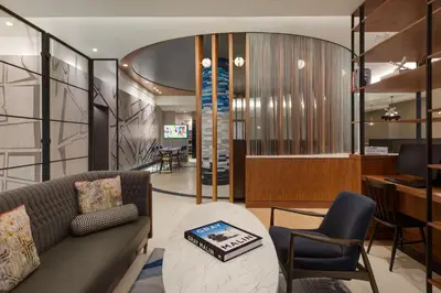 a living room with a couch and a table and chairs at Le Meridien New York, Fifth Avenue in New York
