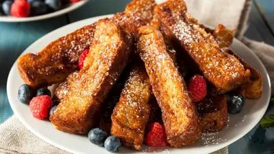 a plate of french fries and berries on a table at Le Meridien New York, Fifth Avenue in New York