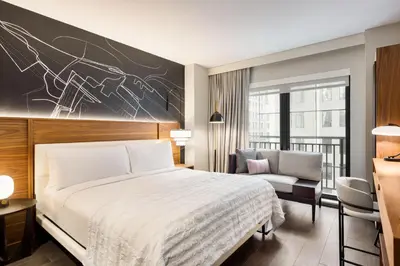 a hotel room with a bed and a chair at Le Meridien New York, Fifth Avenue in New York