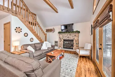a living room with a couch and a fireplace at Walk to Arrowhead Lake Cabin with Private Hot Tub! in Pocono Lake