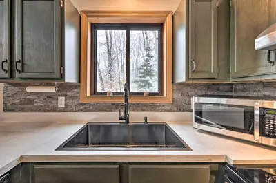 a kitchen with a sink and a window at Walk to Arrowhead Lake Cabin with Private Hot Tub! in Pocono Lake