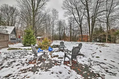 three chairs in a yard covered in snow at Walk to Arrowhead Lake Cabin with Private Hot Tub! in Pocono Lake