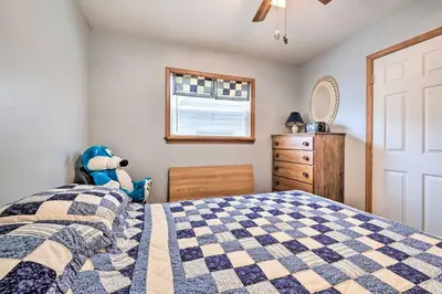 a bedroom with a bed with a blue stuffed animal at Walk to Beach Lakefront Pocono Escape with Fire Pit in Pocono Lake