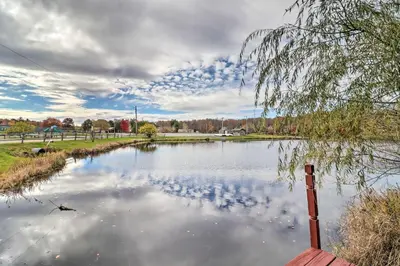 a pond with birds sitting on the water at Walk to Beach Lakefront Pocono Escape with Fire Pit in Pocono Lake