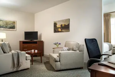 a living room with two chairs and a tv at Hotel Anthracite in Carbondale