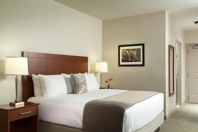 a hotel room with a large bed and two lamps at Hotel Anthracite in Carbondale