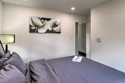 a bedroom with a bed and a picture on the wall at 6 Mi to Camelback Slopes! Home with Game Room in Long Pond