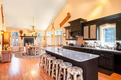 a kitchen with a large island with bar stools at Kelto Kabin in Lake Harmony