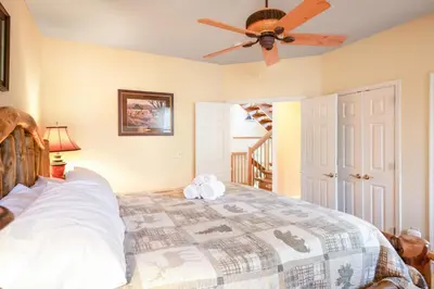 a bedroom with a bed and a ceiling fan at Kelto Kabin in Lake Harmony