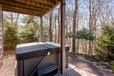 a barbecue grill sitting under a cover on a patio at Kelto Kabin in Lake Harmony