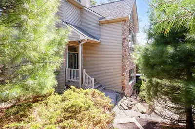 a house with a staircase leading to the front door at Kelto Kabin in Lake Harmony