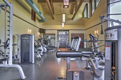 a gym with several treadmills and cardio machines at Walk to Beach Pocono Lake Cabin with Pool Access! in Pocono Lake