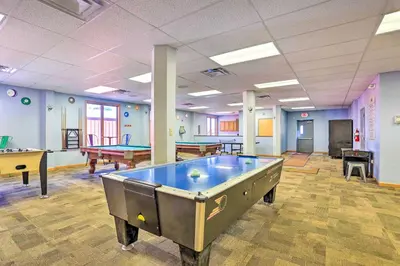 a large room with pool tables and ping pong tables at Walk to Beach Pocono Lake Cabin with Pool Access! in Pocono Lake