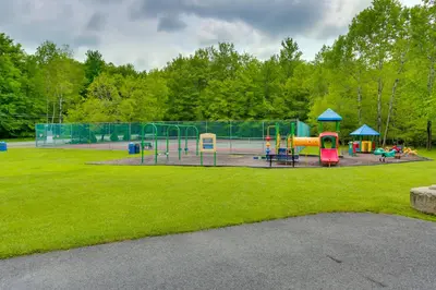 a park with a playground with a playground at Walk to Beach Pocono Lake Cabin with Pool Access! in Pocono Lake