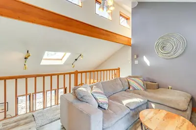 a living room with a couch and a table at Private Spa, Fire Pit and Deck Poconos Home! in Long Pond