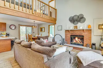 a living room with couches and a fireplace at Private Spa, Fire Pit and Deck Poconos Home! in Long Pond
