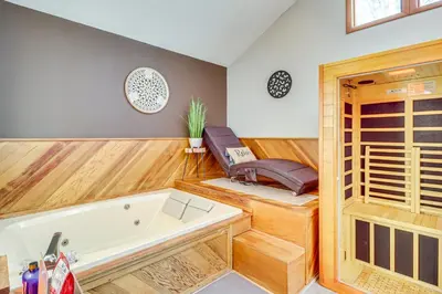 a room with a bath tub and a chair at Private Spa, Fire Pit and Deck Poconos Home! in Long Pond