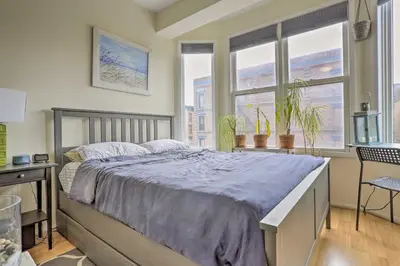 a bedroom with a large bed and a window at Hoboken Studio Near Dining about 15 Min to NYC! in Hoboken