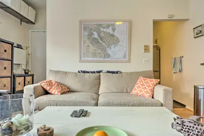 a living room with a couch and a table at Hoboken Studio Near Dining about 15 Min to NYC! in Hoboken