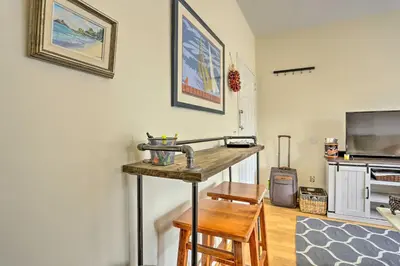 a living room with a table and a tv at Hoboken Studio Near Dining about 15 Min to NYC! in Hoboken