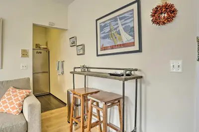 a living room with a table and two stools at Hoboken Studio Near Dining about 15 Min to NYC! in Hoboken