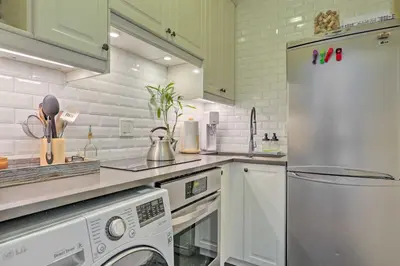 a kitchen with a refrigerator and a washer and dryer at Hoboken Studio Near Dining about 15 Min to NYC! in Hoboken