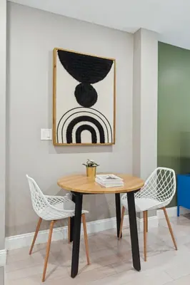 a table and two chairs in a room with a painting at Stay at Luna on Callowhill in Philadelphia