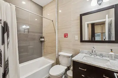 a bathroom with a tub and a toilet and a sink at Stay at Luna on Callowhill in Philadelphia