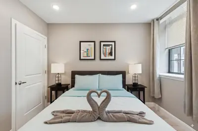 two towels in the shape of a heart are on a bed at Stay at Luna on Callowhill in Philadelphia