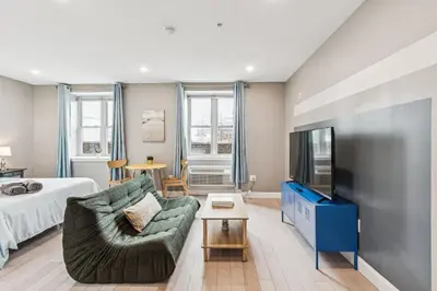 a living room with a couch and a tv at Stay at Luna on Callowhill in Philadelphia