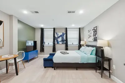 a bedroom with a bed and a table and a tv at Stay at Luna on Callowhill in Philadelphia