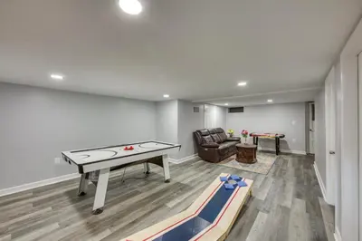 a living room with a ping pong table and a couch at 1 Mi to Hersheypark Family Home with Game Room! in Hershey