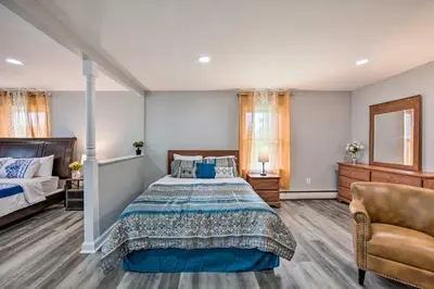 a bedroom with a bed and a couch and a chair at 1 Mi to Hersheypark Family Home with Game Room! in Hershey