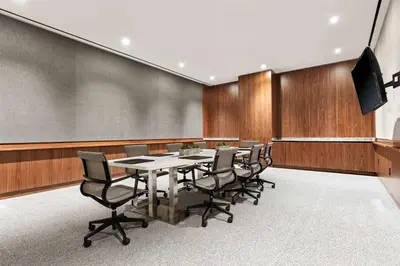 a conference room with a table and chairs and a screen at Grayson Hotel in New York
