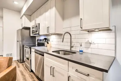 a kitchen with white cabinets and a sink at Trendy Apt with Laundry Machines Less Than 3 Mi to Dtwn in Philadelphia
