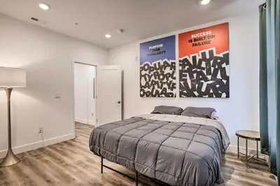 a bedroom with a bed and a large painting on the wall at Trendy Apt with Laundry Machines Less Than 3 Mi to Dtwn in Philadelphia