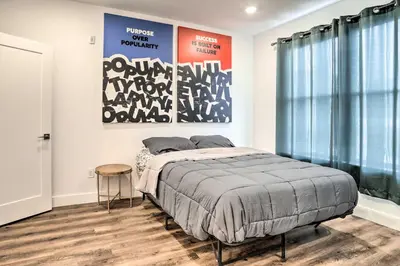a bedroom with a bed and a poster on the wall at Trendy Apt with Laundry Machines Less Than 3 Mi to Dtwn in Philadelphia