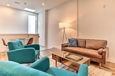 a living room with two couches and a table at Central Pet-Friendly Apt - Minutes to Dtwn! in Philadelphia